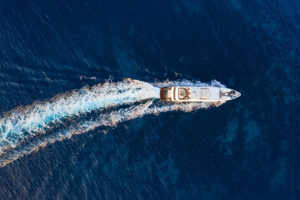 Aerial view on fast boat on blue Mediterranean sea at sunny day. Fast ship on the sea surface.