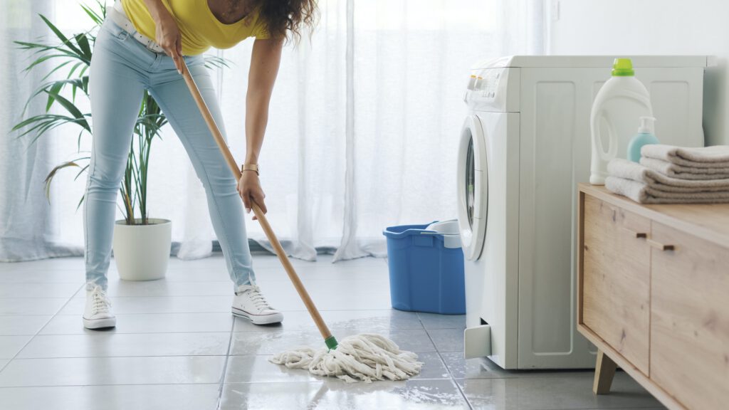 Broken washing machine leaking on the floor