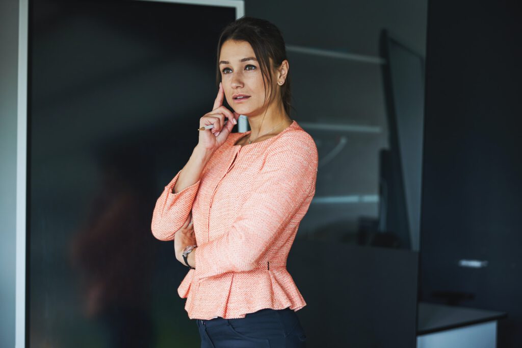 Young Caucasian woman business analyst concerned making difficult decision and lost in thought in